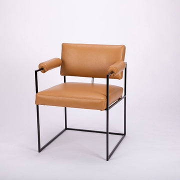 Classic modern leather dining chair designed in 1968 by Milo Baughman. Orange color with black metal frame.