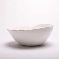 Spiral Bowl made of Portuguese ceramic with an matte white finish and a swirling ridge that spirals from the outer edges of the bowl towards the center.