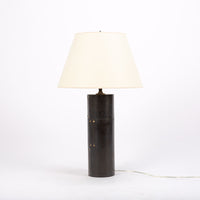 Yul table lamp with cylindrical brass plates applied to create a simple clean, industrial form.