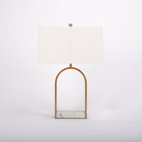 Simple and elegant Rylan table Lamp with a softly curved shade, steel finished in a antique brass forms the open arch, and a foundation of white marble.
