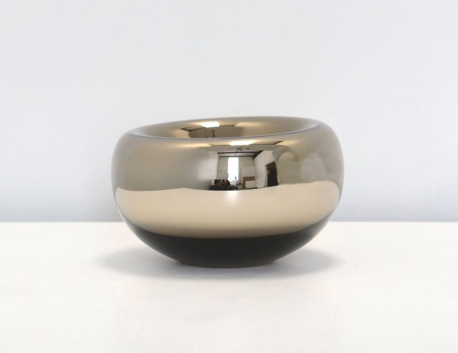 Echo Vessels with rounded asymmetrical shapes of handblown Czech glass in transparent colors with dimpled void at its top.