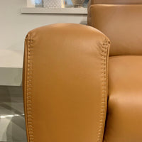 Orange leather Vogue three seater sofa equipped with a state of the art power mechanism and touchpad that individually controls headrest and footrest. Closed up arm rest view.